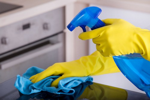 Carpet cleaning technician preparing equipment safely in a home setting