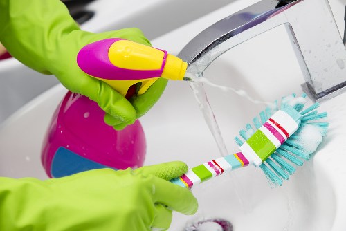 Professional oven cleaner working in a W12 home kitchen