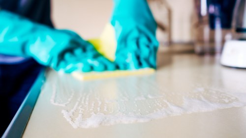 Clean kitchen surfaces and sink area in a W12 home cleaning appointment